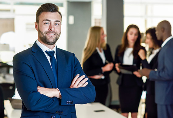 professional_man looking_at_camera_while others_are_having_chat